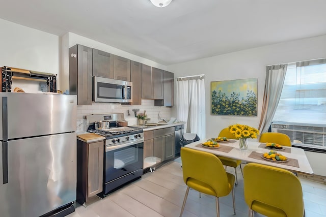 kitchen with appliances with stainless steel finishes and tasteful backsplash