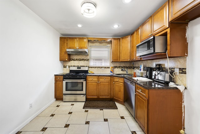 1432 44th St, North Bergen, NJ 07047 - kitchen featuring a sink, under cabinet range hood, tasteful backsplash, and stainless steel appliances