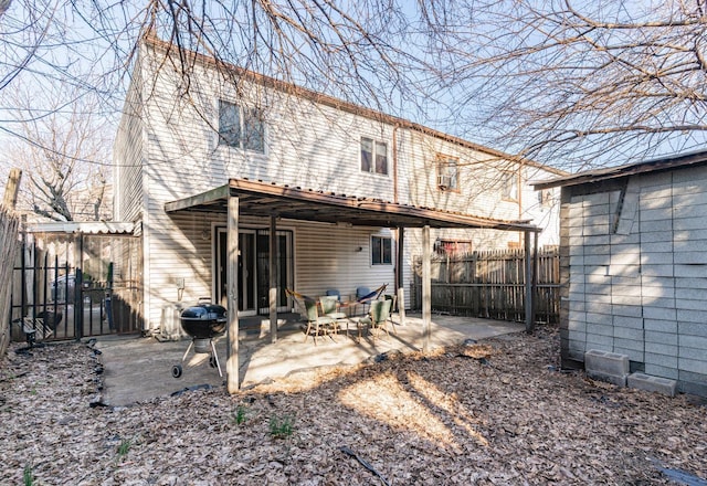 back of house featuring a patio area and fence