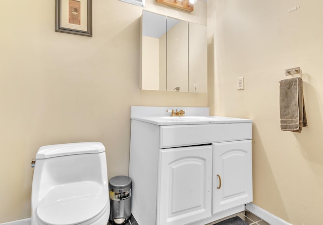 half bath featuring baseboards, toilet, and vanity