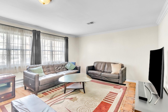 living room featuring light wood-type flooring, visible vents, and ornamental molding