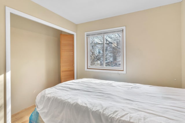 bedroom with a closet and wood finished floors