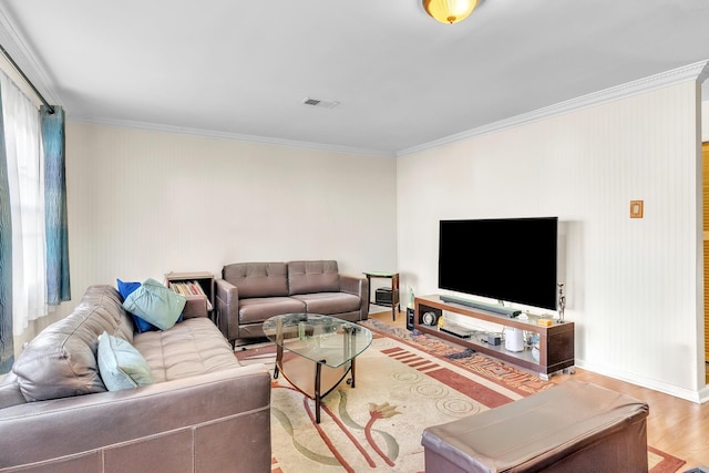 living area featuring visible vents, ornamental molding, baseboards, and wood finished floors