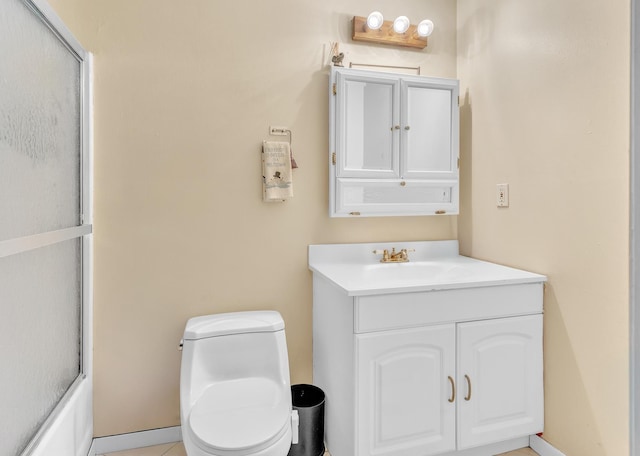 bathroom featuring a shower with shower door, toilet, and vanity