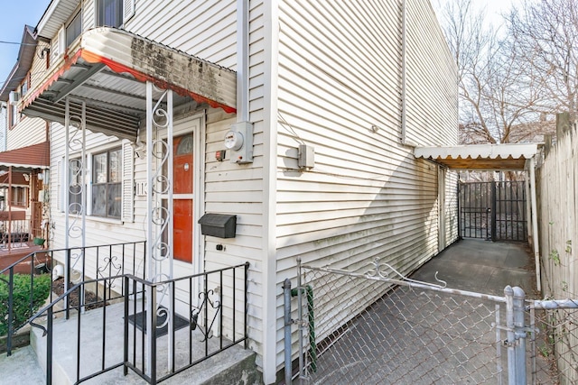 view of side of home featuring a gate and fence