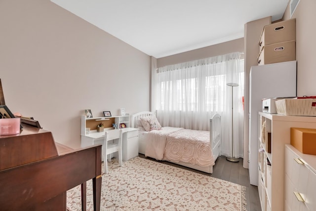 bedroom with visible vents and wood finished floors