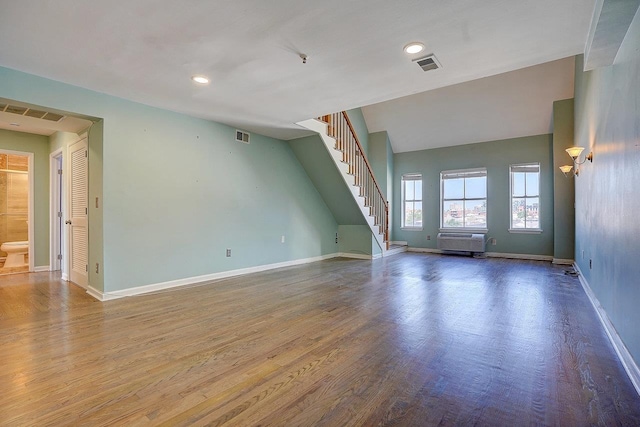 54 Polk St, Newark, NJ 07105 - unfurnished living room with an AC wall unit, stairs, wood finished floors, and recessed lighting