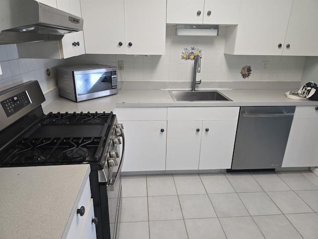 54 Polk St, Newark, NJ 07105 - kitchen featuring stainless steel appliances, under cabinet range hood, white cabinets, and light countertops