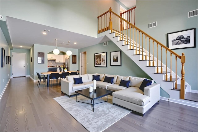 54 Polk St, Newark, NJ 07105 - living room with dark wood-style floors, stairway, a high ceiling, and recessed lighting
