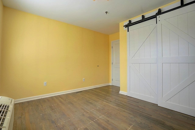 54 Polk St, Newark, NJ 07105 - unfurnished bedroom with wood finished floors and a barn door