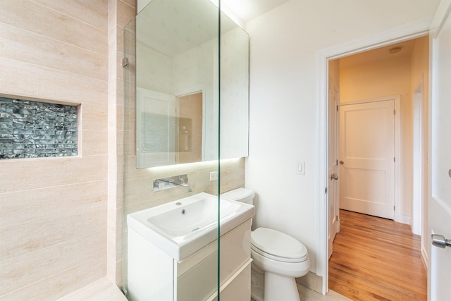 bathroom featuring hardwood / wood-style flooring, vanity, and toilet