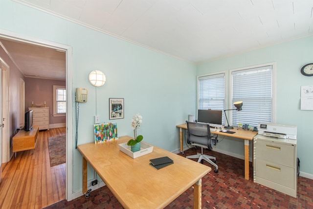 office area featuring baseboards, brick floor, and ornamental molding