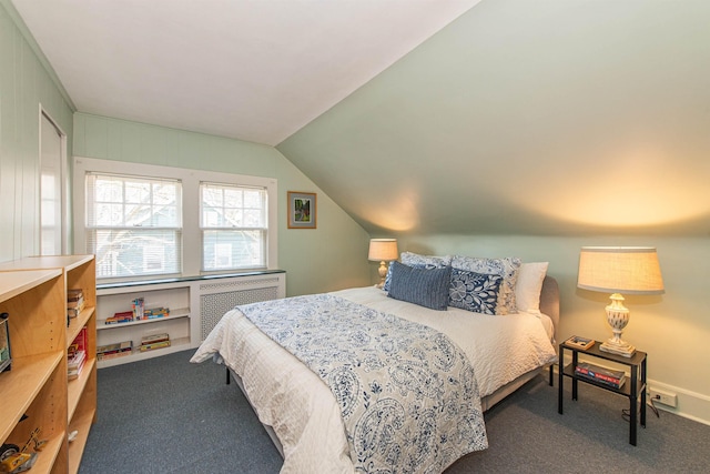 carpeted bedroom with vaulted ceiling and radiator