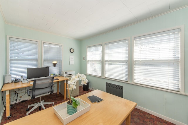 office area with baseboards, radiator heating unit, brick floor, and ornamental molding