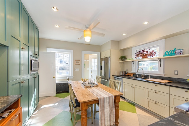 kitchen with open shelves, light floors, stainless steel appliances, and green cabinetry