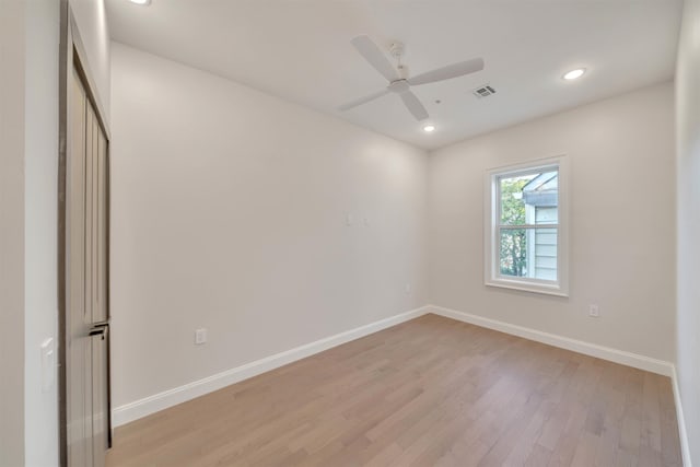 spare room featuring ceiling fan and light hardwood / wood-style flooring