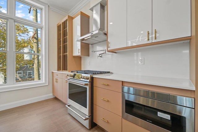 kitchen featuring extractor fan, light hardwood / wood-style flooring, ornamental molding, white cabinets, and stainless steel gas stove