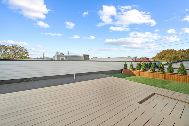 wooden deck featuring a yard