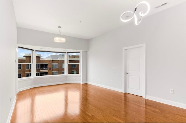 unfurnished room featuring wood-type flooring