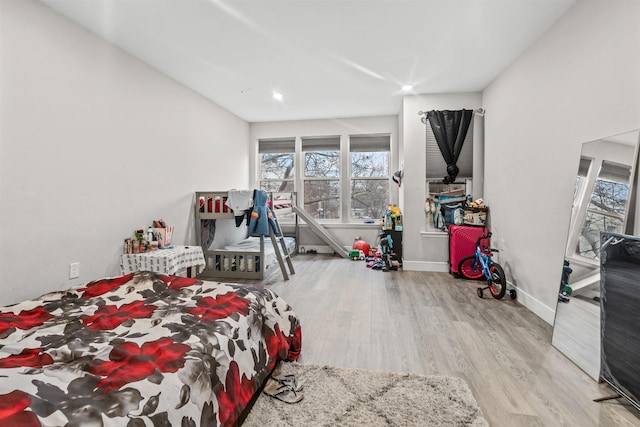 bedroom featuring wood finished floors and baseboards