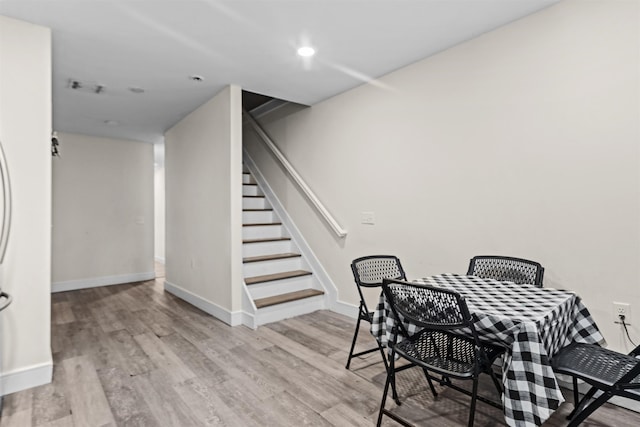 dining room featuring recessed lighting, stairway, light wood-style flooring, and baseboards