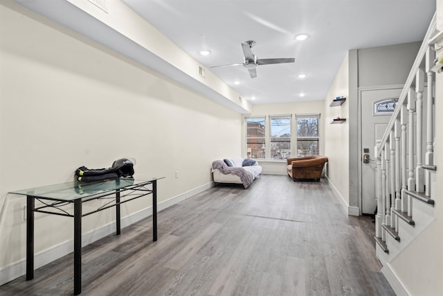 interior space with stairway, a ceiling fan, wood finished floors, baseboards, and recessed lighting