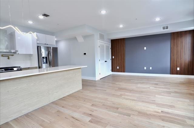 443 Bergen Ave Unit 3, Jersey City, NJ 07304 - kitchen featuring stainless steel fridge, white cabinets, light wood-style floors, light countertops, and recessed lighting