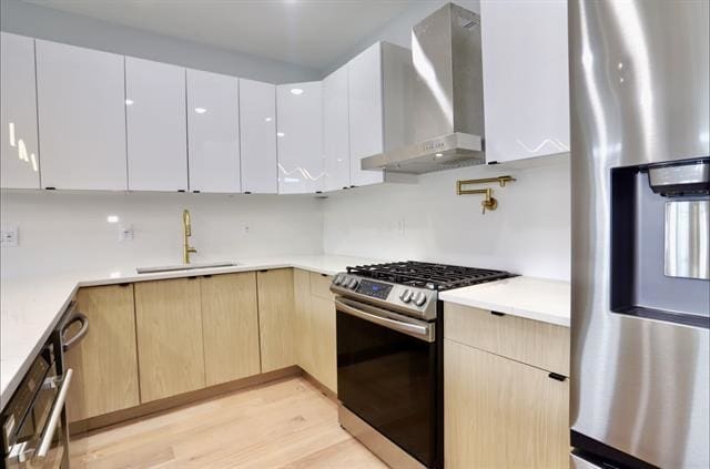 443 Bergen Ave Unit 3, Jersey City, NJ 07304 - kitchen with stainless steel appliances, wall chimney exhaust hood, modern cabinets, and light brown cabinets