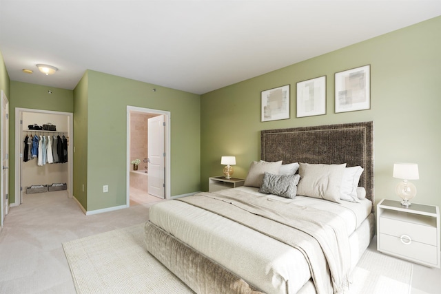 15 Enterprise Ct Unit 211, Jersey City, NJ 07305 - bedroom with a closet, a walk in closet, baseboards, light colored carpet, and ensuite bathroom