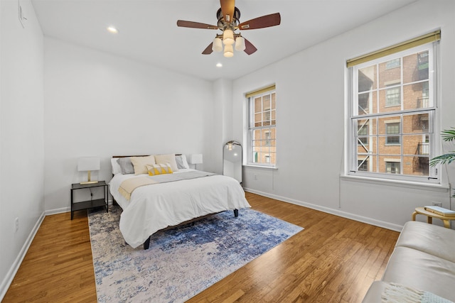 bedroom with recessed lighting, baseboards, wood finished floors, and a ceiling fan