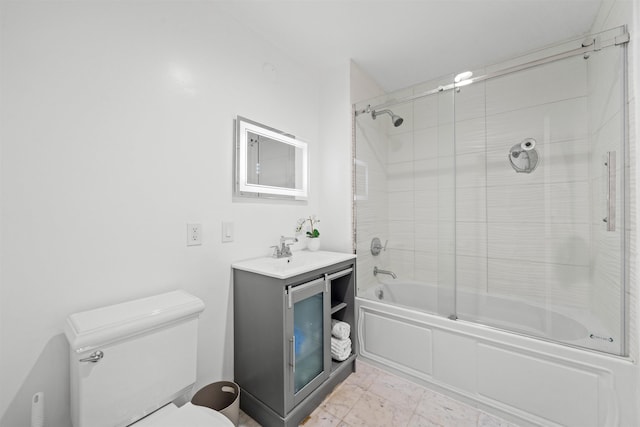 bathroom with enclosed tub / shower combo, toilet, and vanity