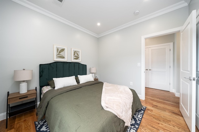 bedroom featuring hardwood / wood-style floors and ornamental molding