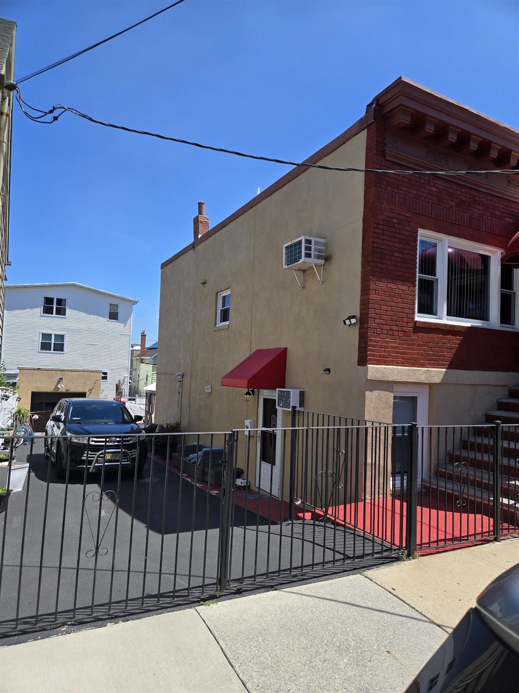 6206 Meadowview Ave, North Bergen, NJ 07047 - exterior space with a fenced front yard, stucco siding, and brick siding