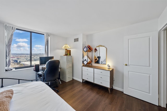 bedroom featuring wood finished floors, visible vents, and baseboards