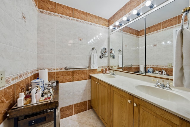 bathroom featuring double vanity, a sink, and tile walls