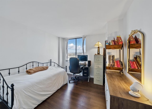 bedroom featuring dark wood finished floors