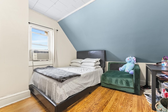 26 E 49th St, Bayonne, NJ 07002 - bedroom featuring vaulted ceiling, wood finished floors, baseboards, and cooling unit