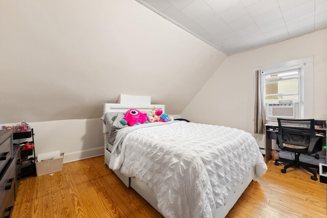 26 E 49th St, Bayonne, NJ 07002 - bedroom featuring light wood-style flooring, cooling unit, lofted ceiling, and baseboards