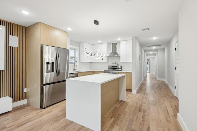 27 E 16th St Unit 2, Bayonne, NJ 07002 - kitchen featuring appliances with stainless steel finishes, wall chimney exhaust hood, modern cabinets, light countertops, and recessed lighting