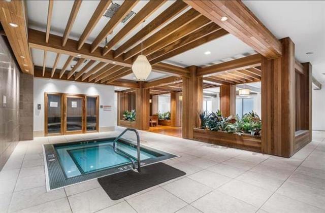 view of swimming pool featuring an indoor in ground hot tub and a swimming pool