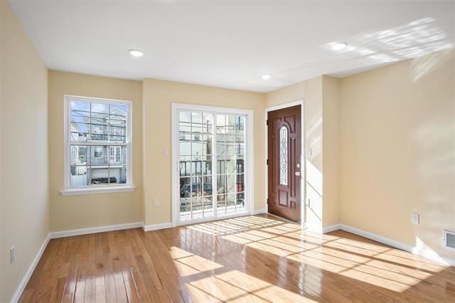 foyer entrance with light wood-type flooring