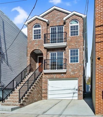 view of front of house featuring a garage and a balcony