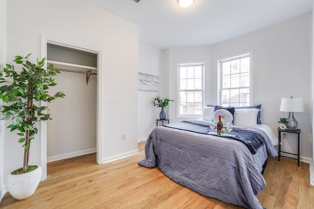 bedroom with a closet and light hardwood / wood-style flooring