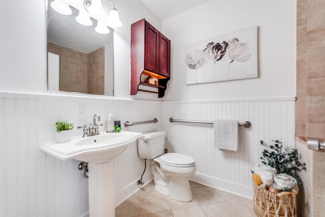 bathroom with sink, tile patterned flooring, and toilet