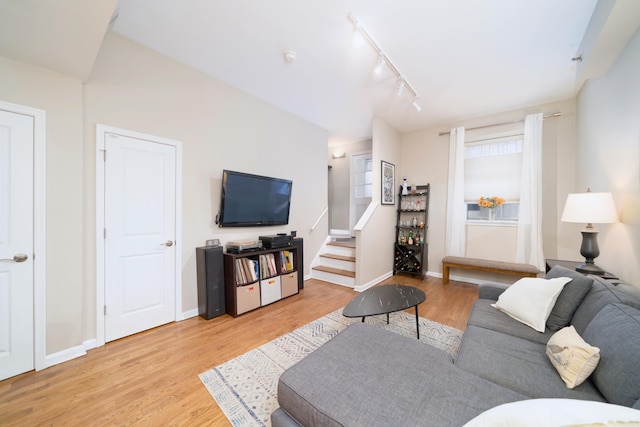 186 Wayne St Unit D-106, Jersey City, NJ 07302 - living area featuring light wood finished floors, track lighting, baseboards, and stairs