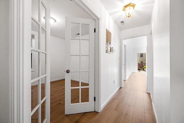 127 Jane St, Weehawken, NJ 07086 - hallway featuring light wood-style floors, baseboards, and french doors