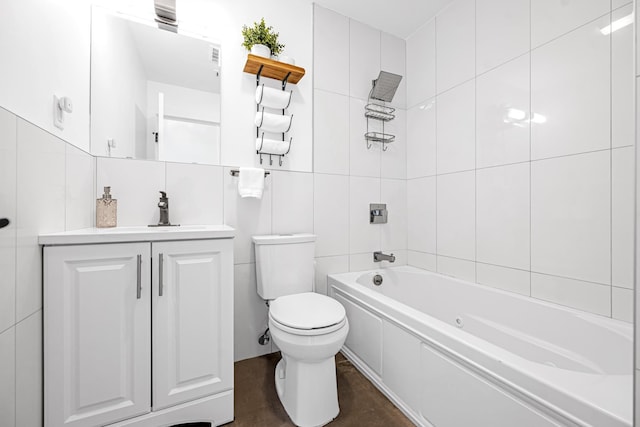 127 Jane St, Weehawken, NJ 07086 - bathroom with tile walls, toilet, vanity, and shower / tub combination