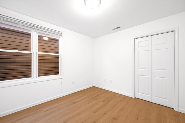 127 Jane St, Weehawken, NJ 07086 - unfurnished bedroom with light wood-type flooring, baseboards, and a closet