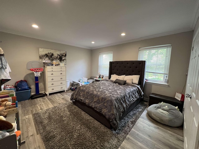 bedroom featuring ornamental molding and hardwood / wood-style flooring