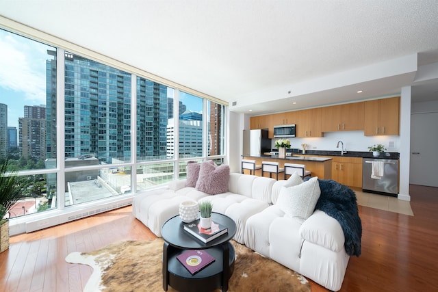 1 Shore Ln Unit 1208, Jersey City, NJ 07310 - living room with a city view, light wood-type flooring, and a wall of windows